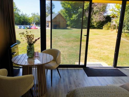 a room with a table and chairs and a large window at Il Giardino Segreto in Waterloo