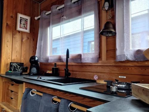 a kitchen with a sink and a window at La Toue Charme in Angers