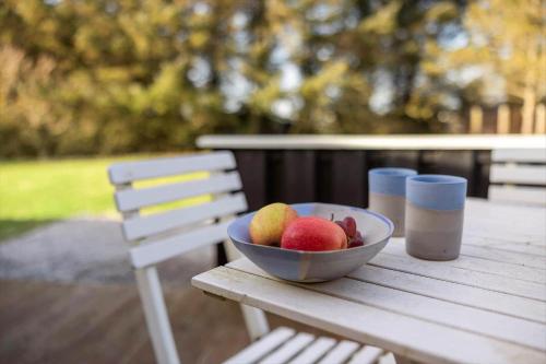 a bowl of fruit sitting on a wooden table at LN1822-Hjorring-Hojlandet-21 in Hjørring