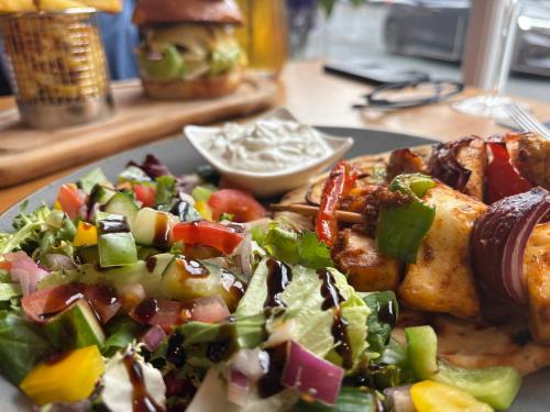 a plate of food with a salad on a table at The Old Gables in Brampton