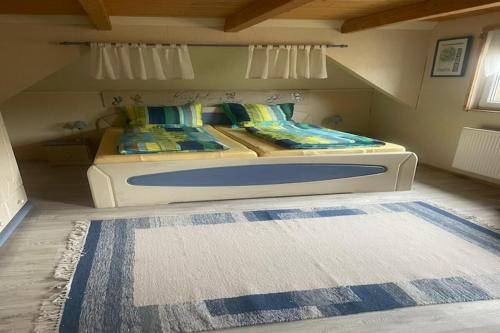 a bedroom with a large bed with a rug on the floor at Lodge in Bohemia with Sauna and Bubble Bath in Kraslice