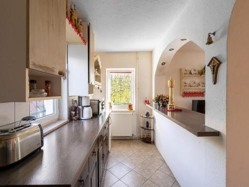 a kitchen with a counter and a window at Lodge in Bohemia with Sauna and Bubble Bath in Kraslice
