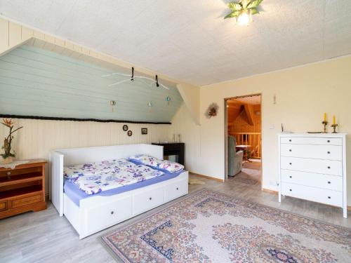 a bedroom with a bed and a dresser at Lodge in Bohemia with Sauna and Bubble Bath in Kraslice