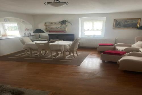 a living room with a table and chairs and a couch at Lodge in Bohemia with Sauna and Bubble Bath in Kraslice