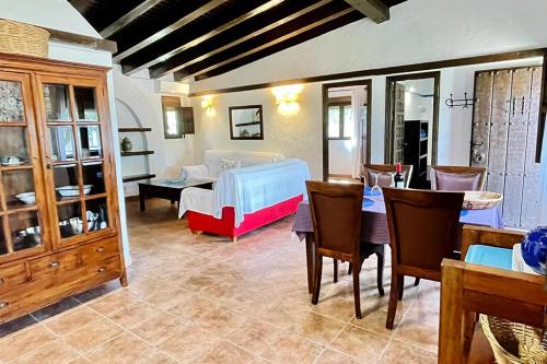 a living room with a bed and a table and chairs at Alojamiento Turístico Nacarum in El Palmar
