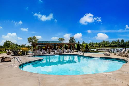 a swimming pool with chairs and a gazebo at HTR Niagara in Grand Island