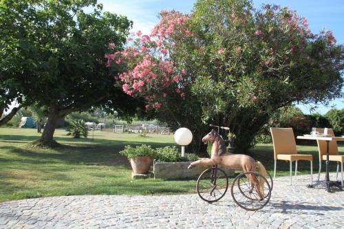 a statue of a dog riding a bike at Hotel Mas Des Barres in Saintes-Maries-de-la-Mer