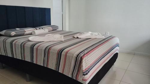 Ένα ή περισσότερα κρεβάτια σε δωμάτιο στο Flat Paulista 10