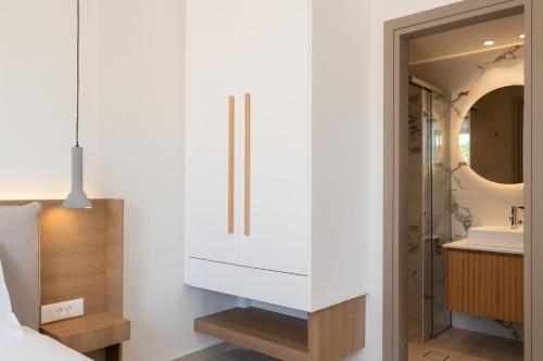 a bathroom with a white cabinet and a sink at See2sea Cozy Apartments in Kolymvari