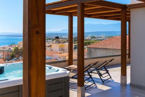 a view from the balcony of a house with a hot tub at See2sea Cozy Apartments in Kolymvari