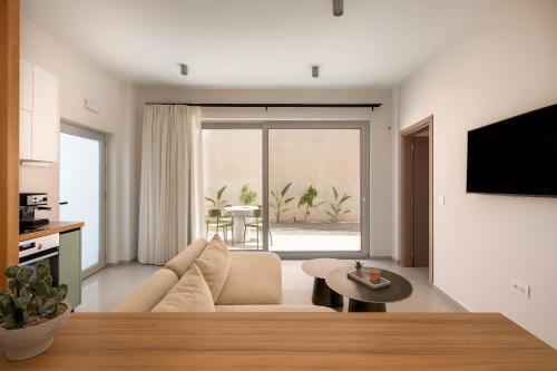 a living room with a couch and a table at See2sea Cozy Apartments in Kolymvari