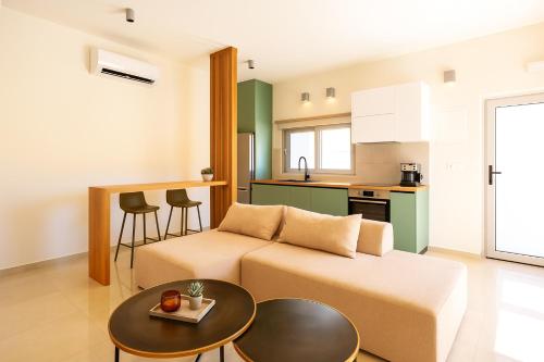 a living room with a couch and a table at See2sea Cozy Apartments in Kolymvari