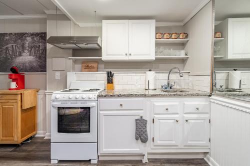 a kitchen with white cabinets and a stove top oven at Basement 1BR! Pet Friendly with Weekly Deals in Acworth