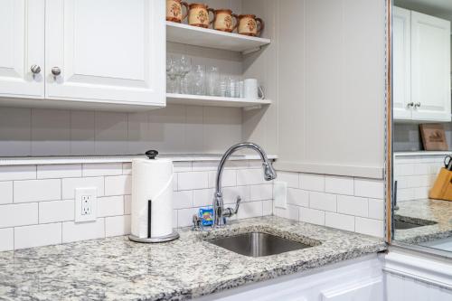a kitchen sink with a roll of paper towels at Basement 1BR! Pet Friendly with Weekly Deals in Acworth