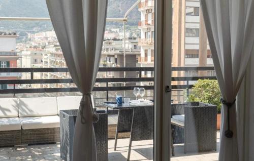 a balcony with a table and a view of a city at Mareluna Penthouse - Luxury Suites & Rooftop in Salerno