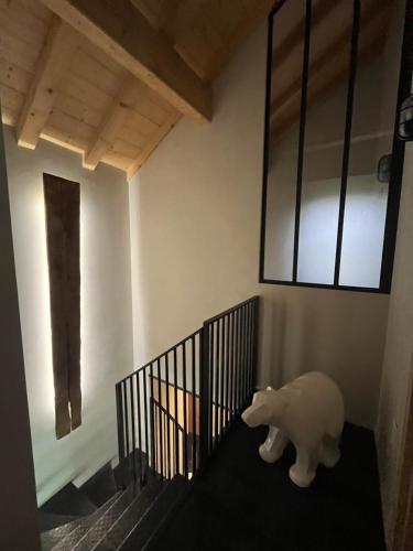 a stuffed elephant sitting on the floor next to a staircase at La loge de la Dolarde in Prémanon