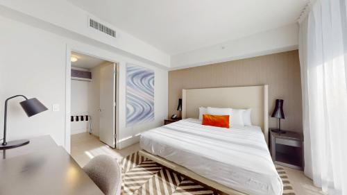 a bedroom with a large white bed and a desk at Hyde Beach House 3BR2BA in Hollywood