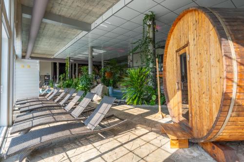 a group of lounge chairs sitting in front of a building at Hôtel et Pavillons Le Petit Manoir du Casino in La Malbaie