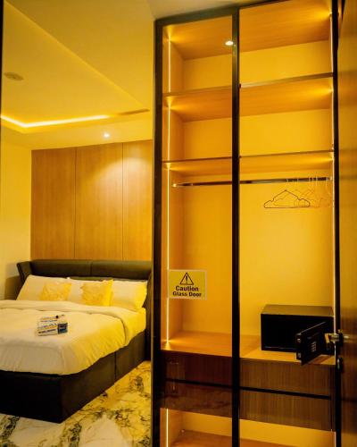 a bedroom with a bed and a glass closet at Azraa 2 Bedroom Luxury Apartment in Awka