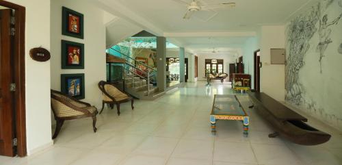a living room with a table on a tiled floor at ayurvedamountainvilla in Nikawatawana