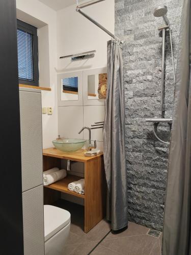 a bathroom with a sink and a shower at Penzion Malý in Krnov