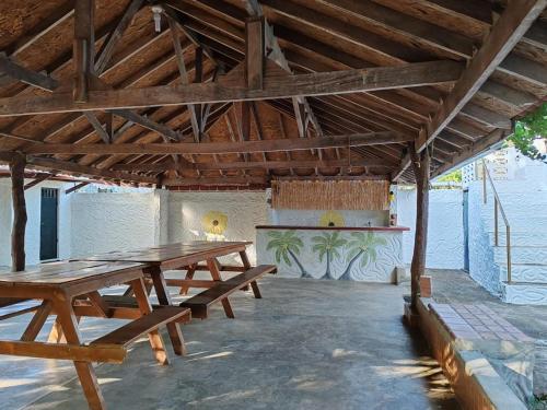 a large wooden picnic table in a room with a counter at Casa playa el rompió in Los Santos