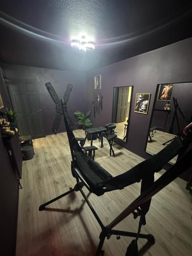 a room with a table and a tripod in a room at Adult only, fetish retreat play space in Ifield