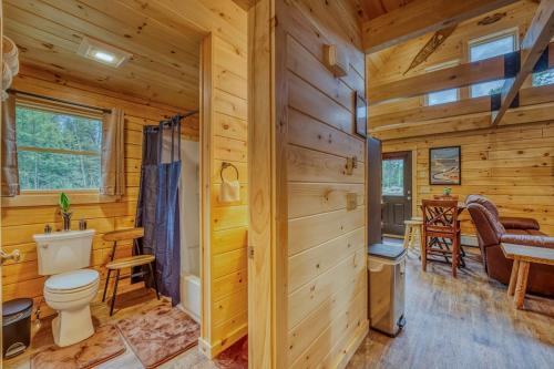 a log cabin bathroom with a toilet and a sink at The Havana Cabana in Bethlehem