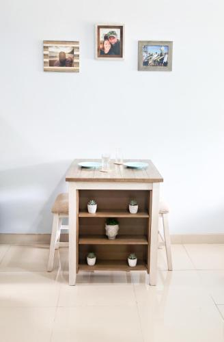 a table in a room with two pictures on the wall at Southern Escapes Apartment in Quepos