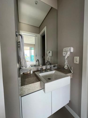 a bathroom with a sink and a mirror at Unique, Ex-Estanconfor, VISTA MAR apto 1510 in Santos