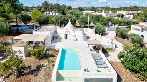 an aerial view of a villa with a swimming pool at Rock'n'Trullo 4 bedroom privatepool by TripOstuni in Ostuni