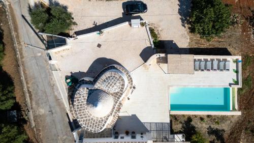 an overhead view of a building with a swimming pool at Rock'n'Trullo 4 bedroom privatepool by TripOstuni in Ostuni