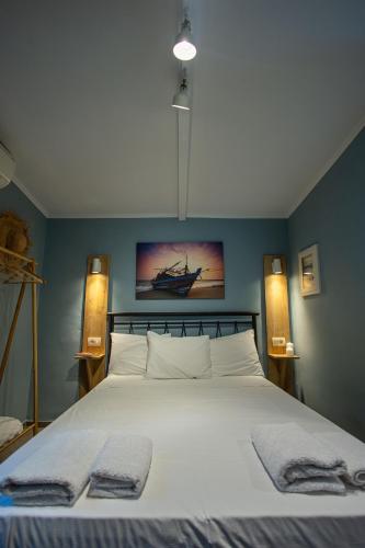 a bedroom with a bed with two towels on it at Aurora Premium Hospitality in Parga
