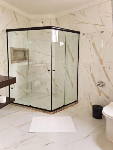 a shower with a glass door in a bathroom at Sintonia com Mar in Angra dos Reis