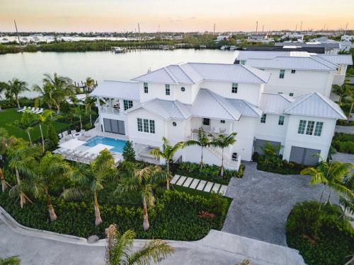 an aerial view of a large white house at The Joyrise House at Solaire Lunara Bay in Key West