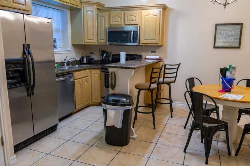eine Küche mit einem Kühlschrank und einem Tisch mit einem Mülleimer in der Unterkunft Ground Floor Condo with Pool unit A - Island Morning Sun 1 in South Padre Island