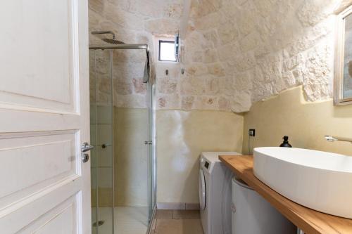 a bathroom with a sink and a shower at Rock'n'Trullo 4 bedroom privatepool by TripOstuni in Ostuni