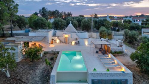 an aerial view of a house with a swimming pool at Rock'n'Trullo 4 bedroom privatepool by TripOstuni in Ostuni