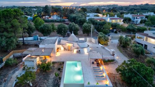 an aerial view of a house with a swimming pool at Rock'n'Trullo 4 bedroom privatepool by TripOstuni in Ostuni