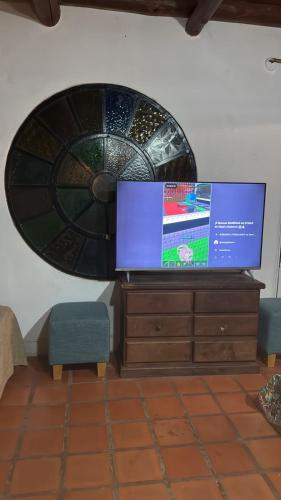 a flat screen tv sitting on top of a dresser at La casa de Pedro in San Roque