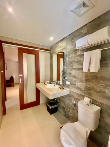 a bathroom with a toilet and a sink at Aloha Boracay Hotel in Boracay