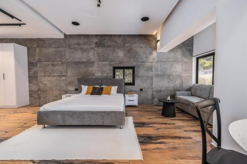a bedroom with a bed and a chair at Hotel 46 in Haifa