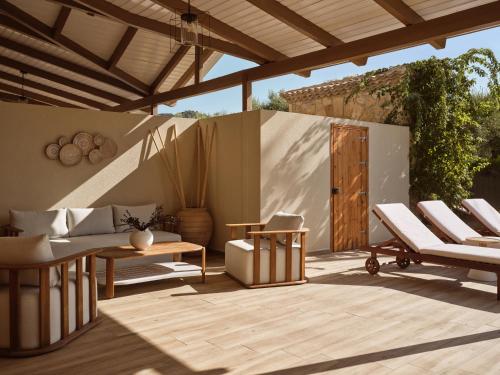 a patio with chairs and a table and a wooden door at Ilision Aqua - Exclusive Private Pool Suites in Argasi