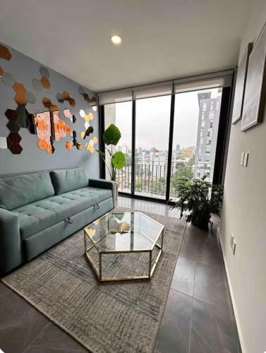 a living room with a couch and a glass table at Departamento Colonia Americana 11 in Guadalajara