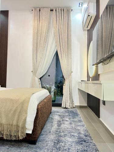 a bedroom with a bed and a large window at 6a Thompson Avenue in Lagos