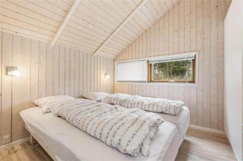 3 camas en una habitación con paredes de madera y ventana en LN776-Hjorring-Bakkestjernevej-6, en Hjørring