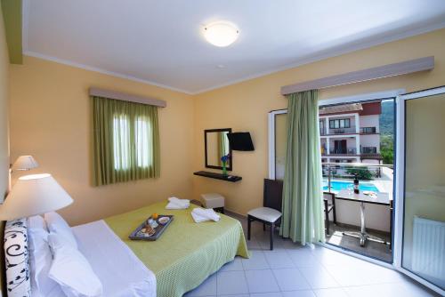 a hotel room with a bed with a tray on it at Christina Studios in Lygia