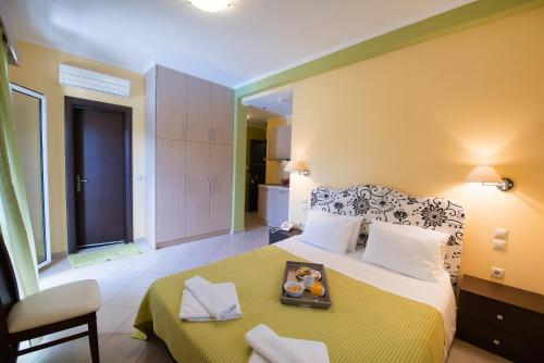 a bedroom with a bed with a tray of food on it at Christina Studios in Lygia