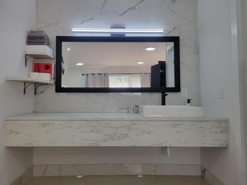 a bathroom with a sink and a mirror at Kevin #2 Studio in Fort Lauderdale