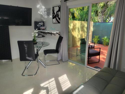 a living room with a couch and a table and chairs at Kevin #2 Studio in Fort Lauderdale